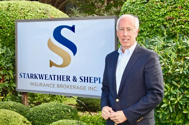 Starkweather & Shepley Insurance sign with a business professional standing in front.