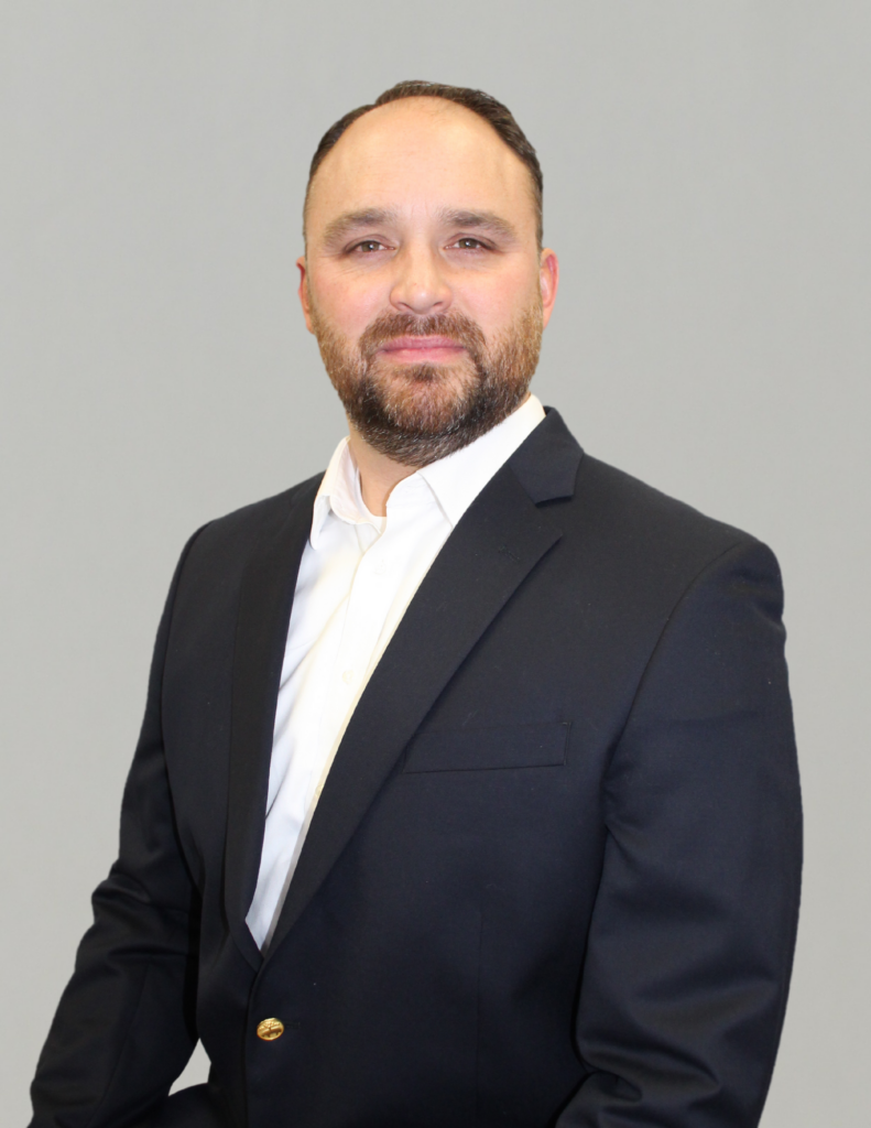 Professional man in a suit against a plain background.