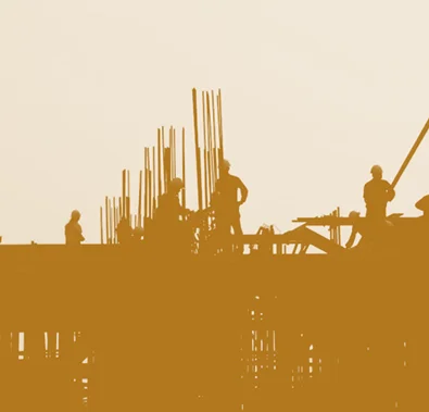 Construction workers on building site, highlighting real estate risk management.