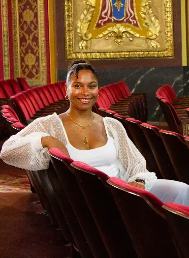 Aliya Ahmed in a theater setting, highlighting her role in arts and entertainment insurance solutions.