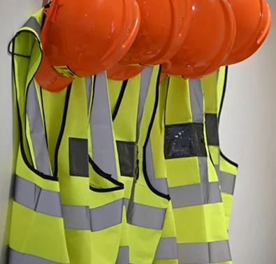 Safety vests and helmets for compliance training by Starkweather & Shepley.