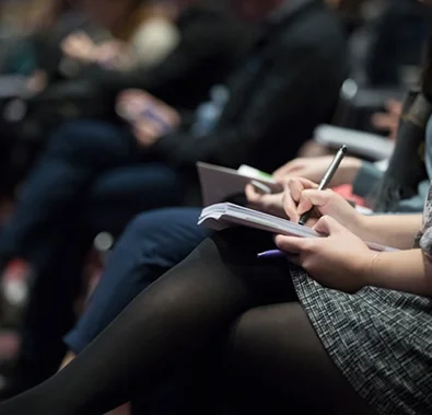 Attendees taking notes at a Starkweather & Shepley loss control seminar.