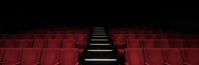 Empty theater with red seats, highlighting entertainment risk solutions.