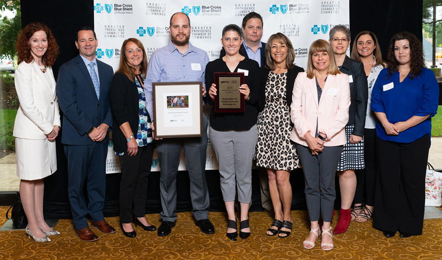 Group receiving an award at Blue Cross Blue Shield event.