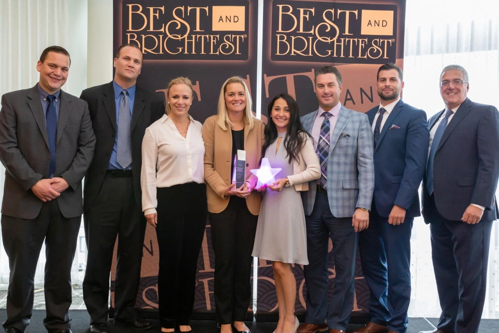Award ceremony group celebrating "Best and Brightest" recognition.