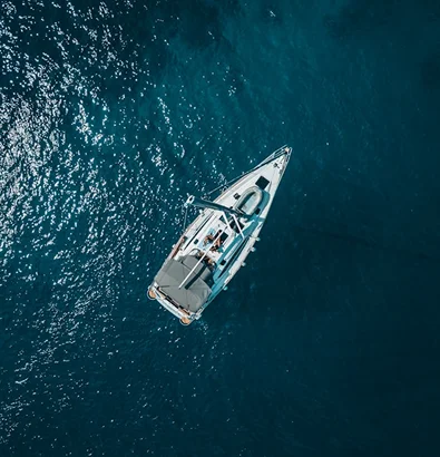 Aerial view of a sailing boat on the water, highlighting specialized watercraft insurance coverage from Travelers.