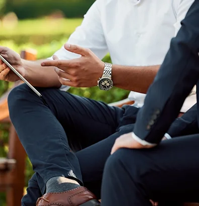 Discussing insurance options outdoors with a tablet, emphasizing protection of valuable collections.